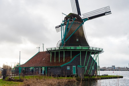 Zaanse Schans, Netherlands - January 10, 2017: Rural Dutch scenery with water canals in Zaanse Schans village known for well-preserved historic windmills and row houses near Amsterdam, Netherlands.のeditorial素材