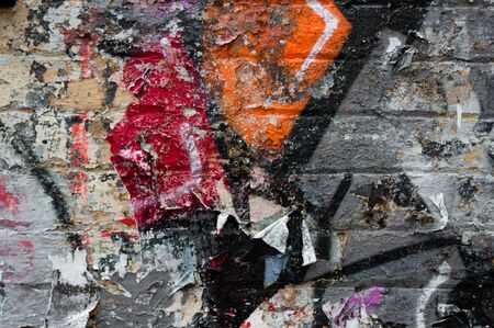 Vintage grunge background with old torn posters and graffiti sprayの写真素材