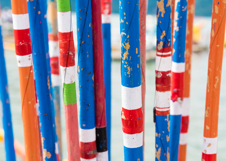 Close-up on bunch of colourful traditional bamboo fishing rodsの写真素材