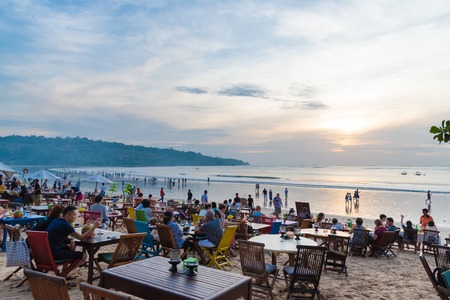 Bali, Indonesia - May 12, 2017: Jimbaran tropical beach is a main popular balinese attraction, famous for the clear, aqua blue water and sea food restaurants in Bali, Indonesia.のeditorial素材