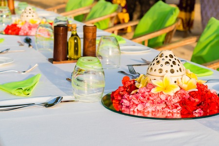 Table setting for wedding reception with red and yellow flowersの写真素材
