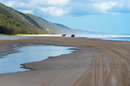 Rainbow Beach, QLD, Australia- December 30, 2017: 4wd vehicles at Rainbow Beach, a popular tourist destination and a gateway to Fraser Island, its name derives from the rainbow-coloured sand dunes.のeditorial素材
