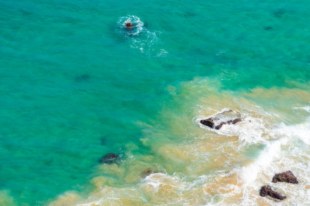 Aerial view over green turquoise water waves in Byron Bay, Australia. Nature background with ocean...
