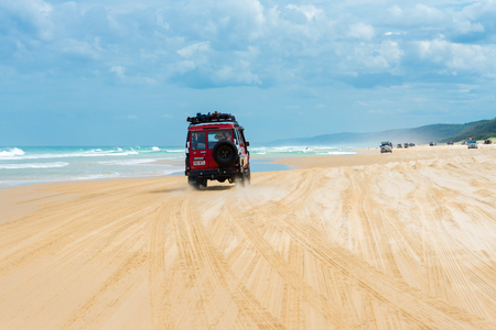 Rainbow Beach, QLD, Australia- December 30, 2017: 4wd vehicles at Rainbow Beach, a popular tourist destination and a gateway to Fraser Island, its name derives from the rainbow-coloured sand dunes.のeditorial素材