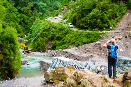 Annapurna Conservation Area, Nepal - July 18, 2018 : Tourist taking photos on the trek in Annapurna Conservation Area, a hotspot destination for mountaineers and Nepal's largest protected area.のeditorial素材