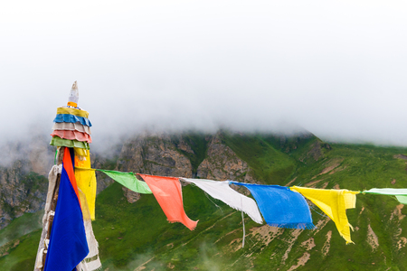 Nar village, Annapurna Conservation Area, Nepal - July 21, 2018 : Traditional buddhist prayer flags over foggy mountain background, are used to bless the surrounding countryside and to promote peaceのeditorial素材