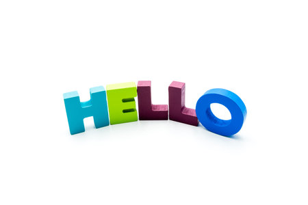 Word HELLO written with colourful wooden letters, isolated over white with copy space. Business...