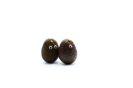 Romantic avocados couple with googly eyes as man and woman, funny food concept for creative...