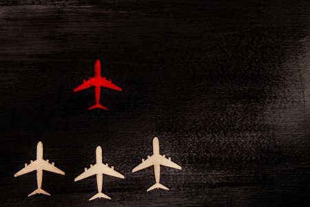 Wooden cutout planes with red plane in front leading them, leadership conceptの写真素材