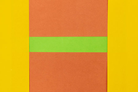 Green, Orange and Yellow coloured paper background, abstract contrast conceptual image