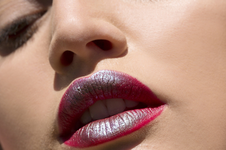 Beauty shot of red and silver lipstick on a females lipsの写真素材