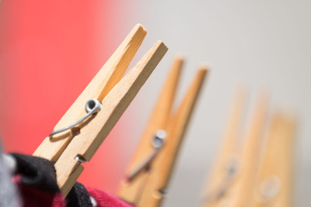 Close up of clothing pegs holding washing on the washline.の写真素材