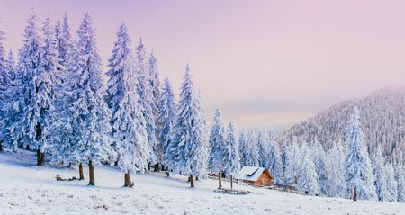 cabin in the mountains in winterの写真素材