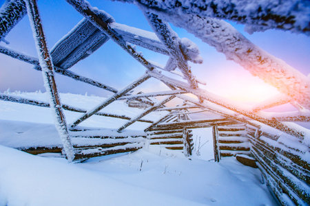 broken hut from the middle covered with snow