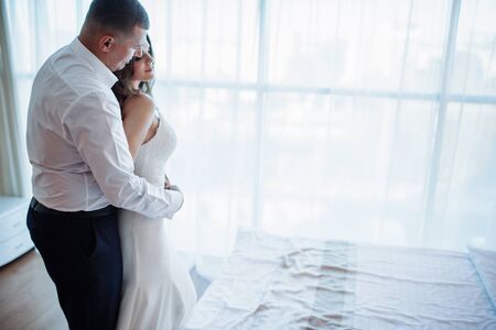 Wedding couple in hotel roomの写真素材