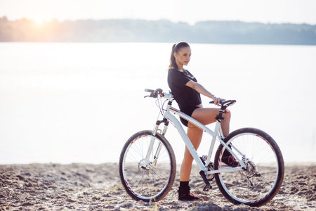 woman on a bicycle near the water