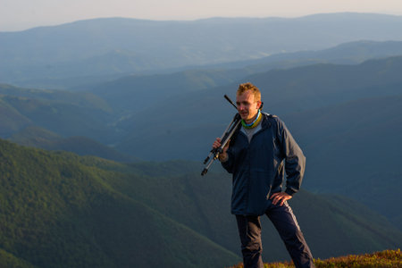 photographer holding a tripod and camera