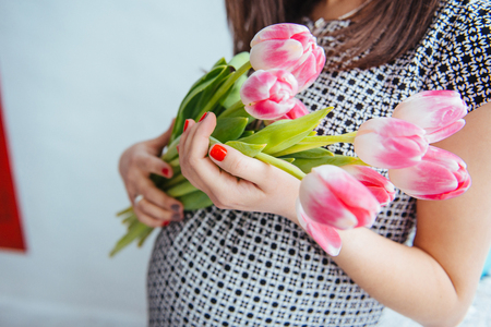 pregnant woman with flowersの写真素材
