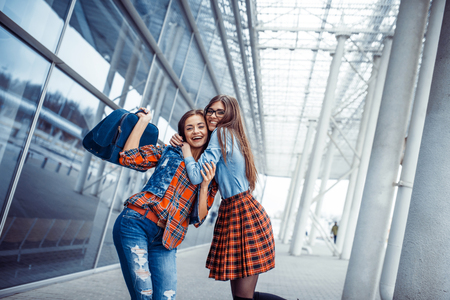 Girls having fun and happy when they met at the airport.Art proc Girls having fun and happy when they met at the airport.Art proc