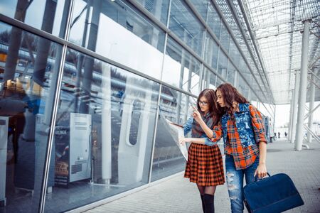 Two girlfriends looking for a route map.Art processing and retouの写真素材