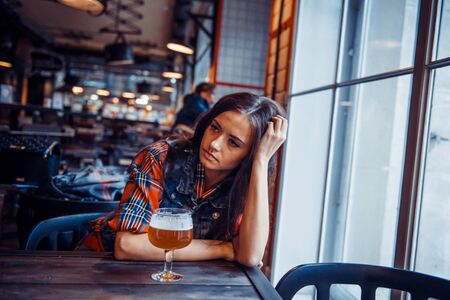 The girl in the cafe with a glass of beer.Art processing and retの写真素材