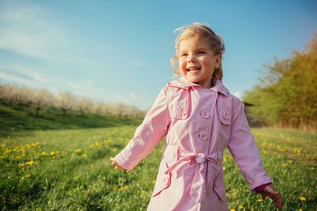 child plays on spring lawn.の写真素材