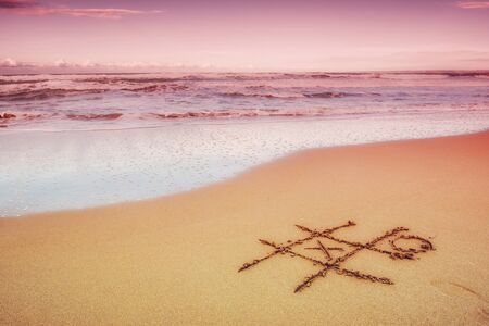 Figures in the sand on the beach.の写真素材