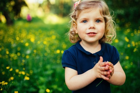 child playing outdoors in the grassの写真素材