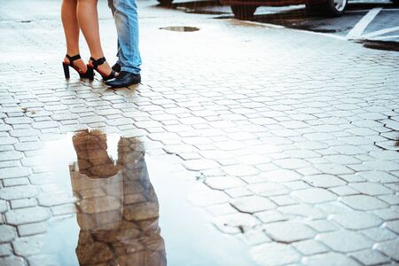reflected in a puddle couple outdoors roadの写真素材