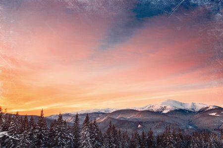 Magic sunset in the snowy mountains. Vintage effect.の写真素材