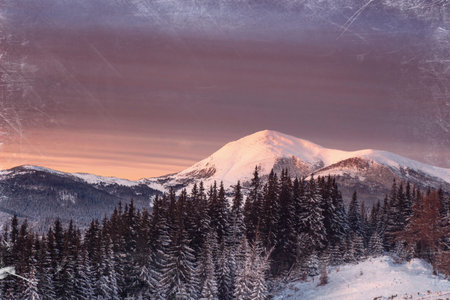 Magic sunset in the snowy mountains. Vintage effect.