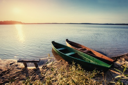 boat on the lake at sunsetの写真素材