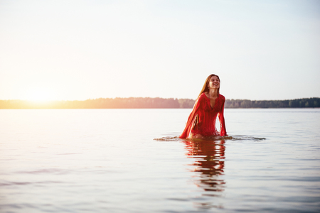 cute girl bathes in waterの写真素材