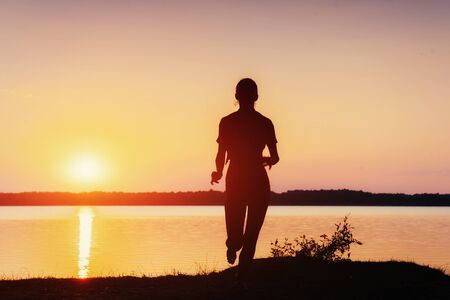 girl at sunset by the lake.の写真素材
