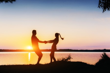 couple on the bike at sunsetの写真素材