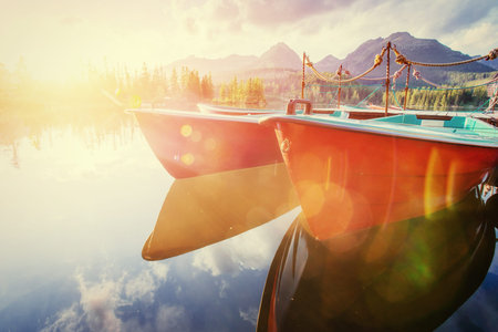 Boat on the dock surrounded mountains. Fantastic Shtrbske Pleso