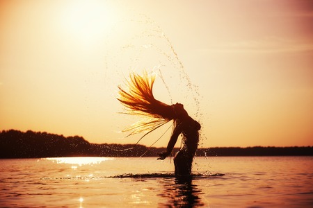 blonde woman on water backgroundの写真素材