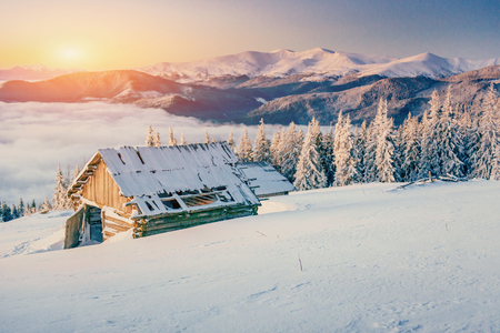 chalets in the mountains at sunsetの写真素材