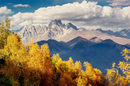 Magic autumn landscape and snow-capped mountain peaks.の写真素材