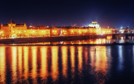 Reflection of Prague caste and the Charles bridge at dusk.の写真素材