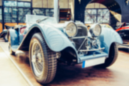 Retro car. Natural blurred background.