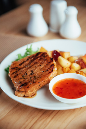 Steak with crispy golden fries and tomato spicy sauceの写真素材