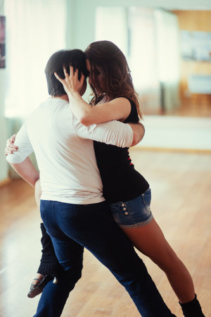 young couple dancing on the roof of a tall building