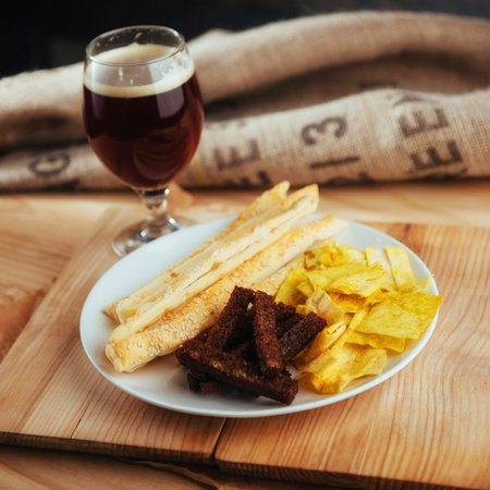 chips, crispy crackers of black bread with sesame and sticks
