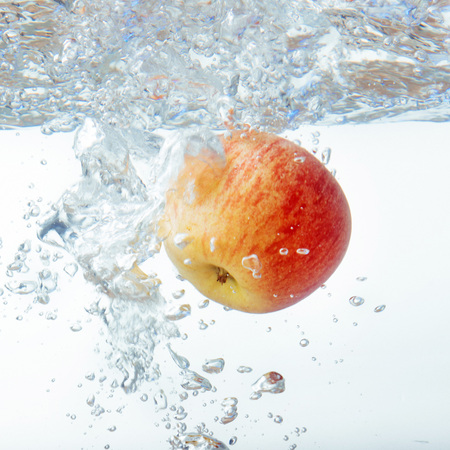 apple in water on a white backgroundの写真素材