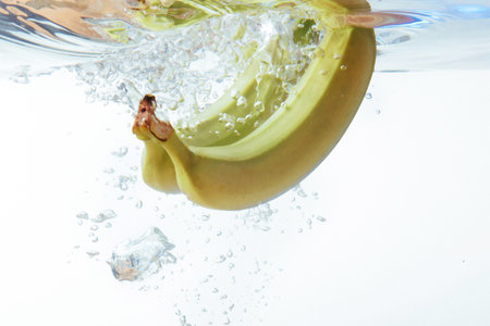 bananas fell into the water, isolated on white.の写真素材