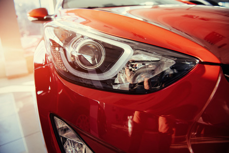 Headlights and hood of sport red car.の写真素材