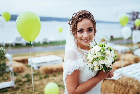 Beautiful brunette bride in a white dress at weddingの写真素材