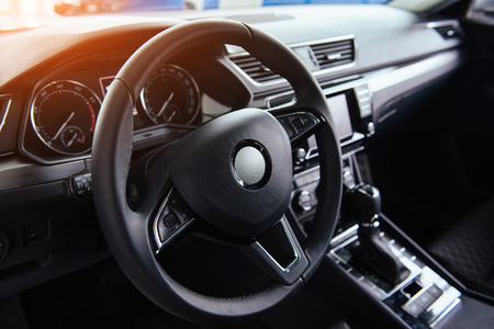 Modern car interior dashboard and steering wheelの写真素材