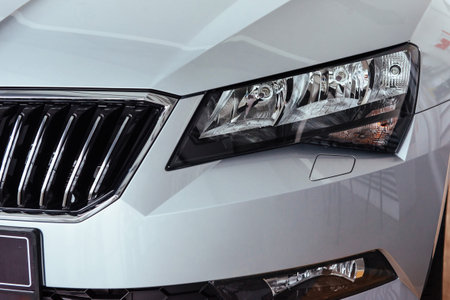 The headlights and the hood of a black sports car
